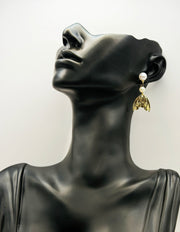 Biya Accessoires gold mermaid tail and double pearl drop earrings.