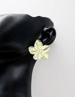 Biya Accessoires textured gold flower stud earrings for women.