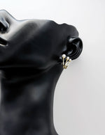 Everyday luxury fashion jewelry gold tone pearl huggies by Biya Accessoires Dubai.