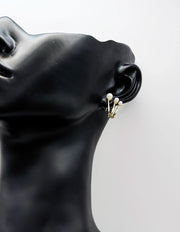 Everyday luxury fashion jewelry gold tone pearl huggies by Biya Accessoires Dubai.