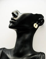 Biya Accessoires gold white enamel and crystal interlocking stud earrings.