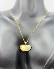 Close-up of premium hypoallergenic imitation jewelry featuring an oyster shell and pearl pendant.