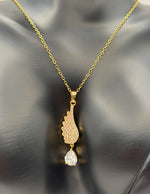 Modern luxury gold and pavé crystal angel wing statement necklace.