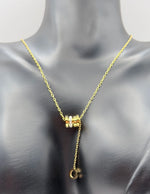 Model wearing an elegant gold lariat drop necklace with pavé stones in Dubai.