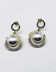 Pair of pearl earrings with gold accents on a white background