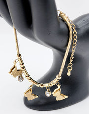 Gold bracelet with butterfly charms on a black mannequin.