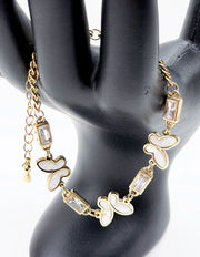 18K gold plated pearlescent butterfly and baguette crystal bracelet by Biya Accessoires.