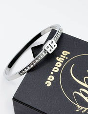 silver plated B monogram crystal bangle by Biya Accessoires.