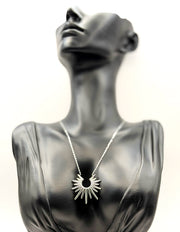 Waterproof silver sunburst spike pendant necklace in green gift box by Biya Accessoires.