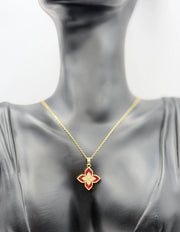 Gold necklace with a red flower pendant on a mannequin