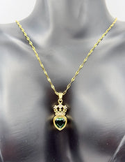 Hypoallergenic gold tiara and heart necklace with clear gemstone.