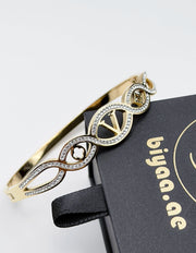 Luxury hypoallergenic gold bracelet with intricate infinity loop design.