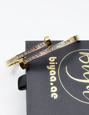 Hypoallergenic gold plated pavé channel bangle architectural jewelry.