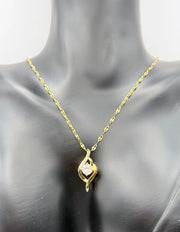 Minimalist 18K gold plated crystal pendant on textured gold chain.