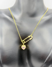 Model wearing an edgy pink heart gold necklace in the UAE market.