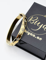 18K gold plated wide band clover bangle with flush set crystals Biya Accessoires.