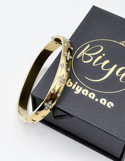 18K gold plated wide band clover bangle with flush set crystals Biya Accessoires.