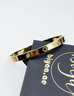 Hypoallergenic non-tarnish high polish gold rigid flat bangle UAE.