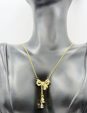 Modern luxury gold and pavé crystal bow statement lariat.