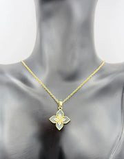 Gold necklace with a floral pendant on a mannequin