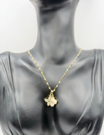 Waterproof gold and white floral necklace for women on silk background.