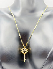 Modern luxury gold and pavé crystal royal key statement necklace.