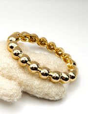 Non-tarnish chunky gold sphere cuff for women Dubai luxury fashion.