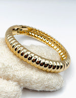 Waterproof 18K gold ribbed hinged bangle Biya Accessoires UAE.