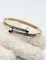 Hypoallergenic gold plated pavé channel bangle architectural jewelry.