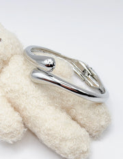 Non-tarnish sculptural wrap statement bangle for women Dubai luxury fashion.