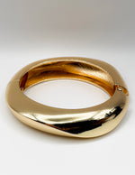 Gold bracelet on a white background