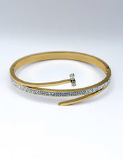 Hypoallergenic gold plated pavé nail motif bangle architectural jewelry.