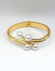 Non-tarnish elegant four pearl statement bangle for women Dubai luxury fashion.