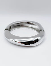 Silver bracelet on a light gray background