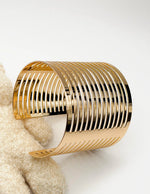 Non-tarnish layered gold statement bangle for women Dubai luxury fashion.