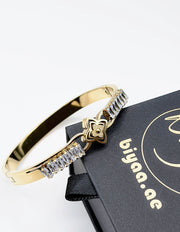 Hypoallergenic non-tarnish high polish gold rigid channel set bangle UAE.