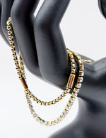 18K gold plated double chain tennis and cylinder bracelet by Biya Accessoires.