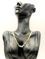 18K gold plated flat herringbone necklace with square crystals by Biya Accessoires.
