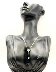 Waterproof silver Y-necklace with black and white floral pendants.
