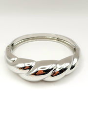 Non-tarnish thick twisted silver statement bangle for women Dubai luxury fashion.