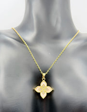 Modern luxury gold and pavé crystal quatrefoil statement necklace.