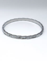 Silver bracelet with small stones on a white background